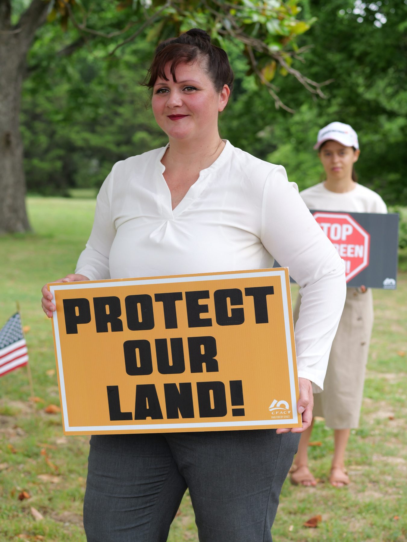 Amber Dawn Ellis holding a Life Liberty and Pursuit of Happiness sign